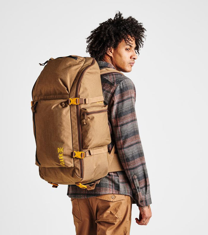 Detail shot of the Roark 5 Day Mule 55L duffel bag in dark khaki, focusing on the straps and hardware.