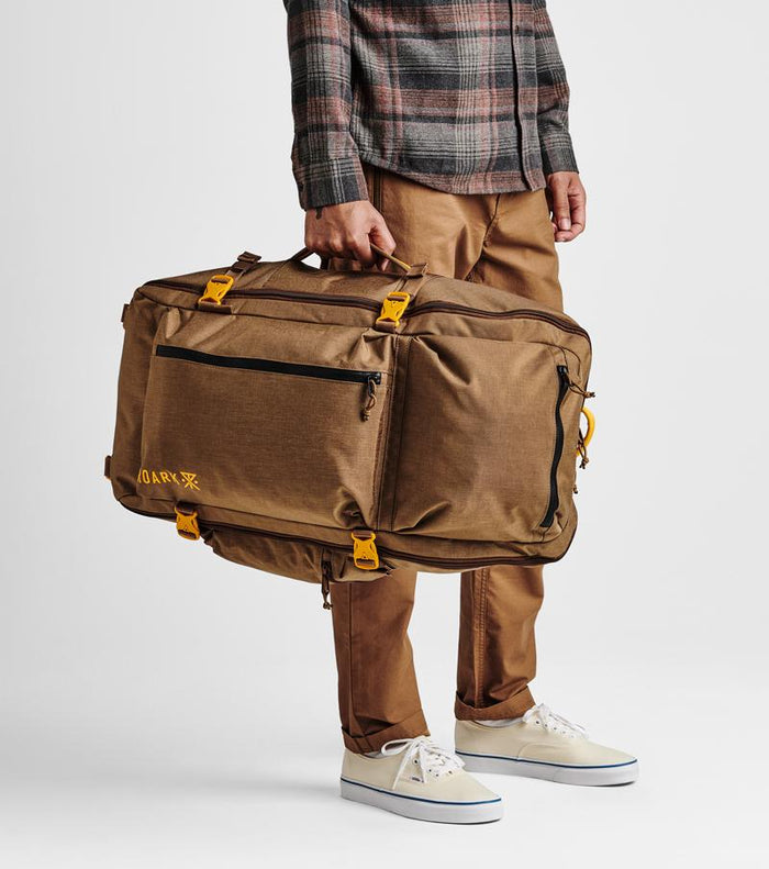 Close up of the Roark 5 Day Mule 55L duffel bag in dark khaki, highlighting the zippered pocket.