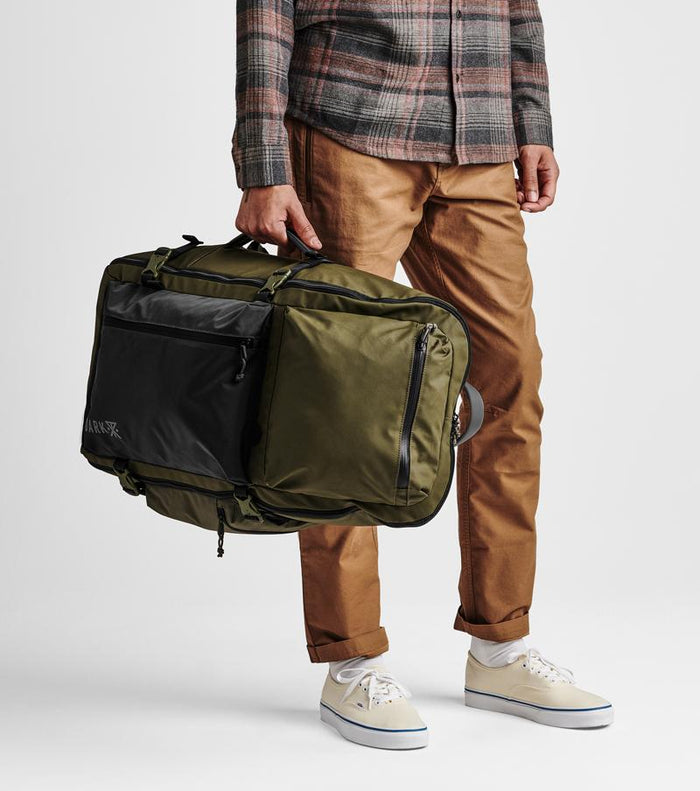 on-model Interior view: The Roark Accomplice Missing Link Bag features a padded laptop sleeve and organizational pockets.