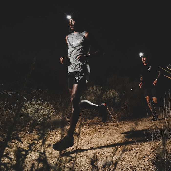 A man wearing the Roark Alta 5" Shorts in Black, demonstrating their comfortable fit and versatile style for a range of activities.