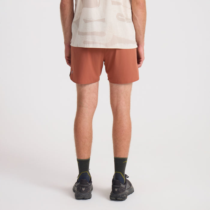 Dynamic orange boardshorts perfect for adventure, featuring a practical Bermuda style suited for active travel and outdoor activities.