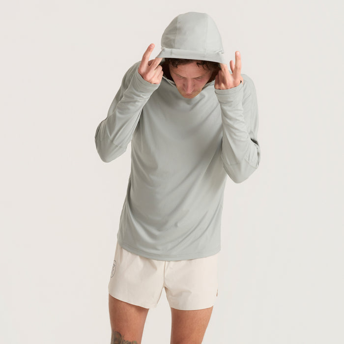 Man in a long-sleeved active shirt with a cap ready for an outdoor adventure