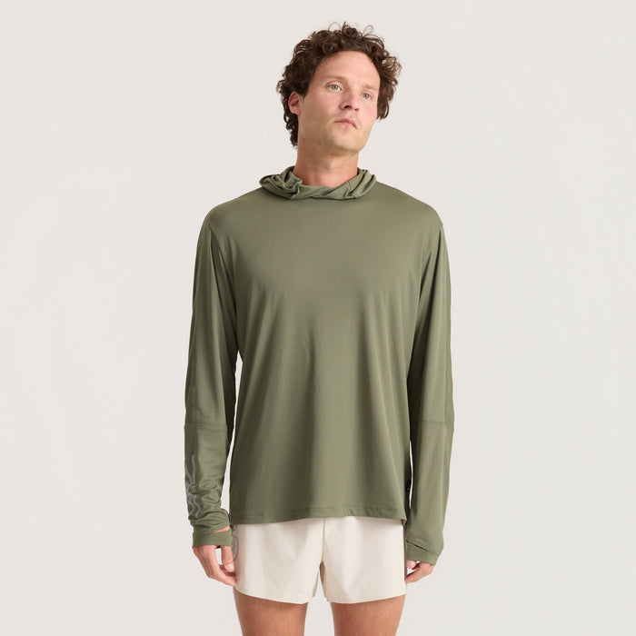 Man dressed in a long-sleeved T-shirt with a unique fashion design, featuring visible pockets, ideal for adventure and travel.