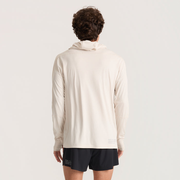 Close-up of a gray long-sleeved Roark running T-shirt featuring a hood and visible durable sleeve design, perfect for outdoor adventures.