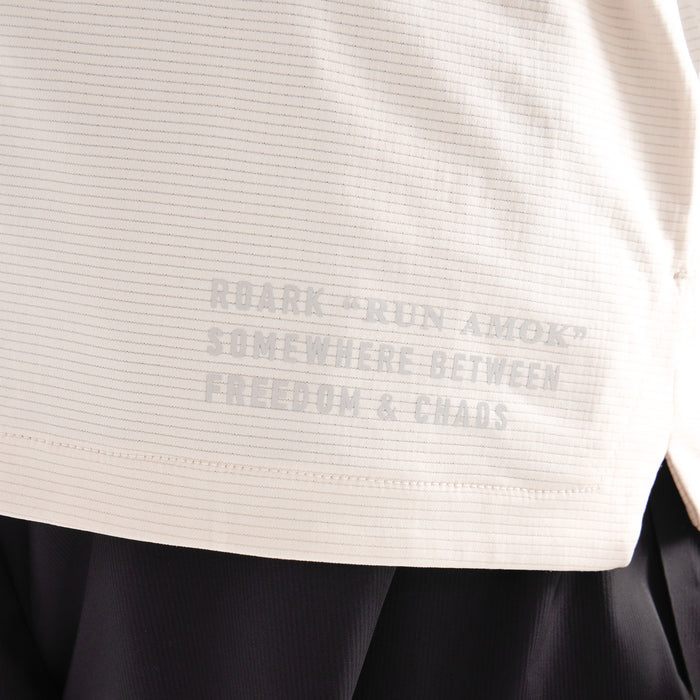 Close-up of a grey, active Roark shirt sleeve, showcasing its durable textile design, suited for adventure and outdoor activities.