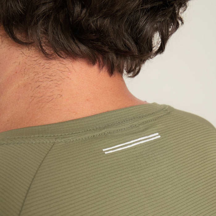 Dynamic man wearing an active Roark shirt, geared for adventure and motion, showcases the perfect balance of outdoor practicality and style.