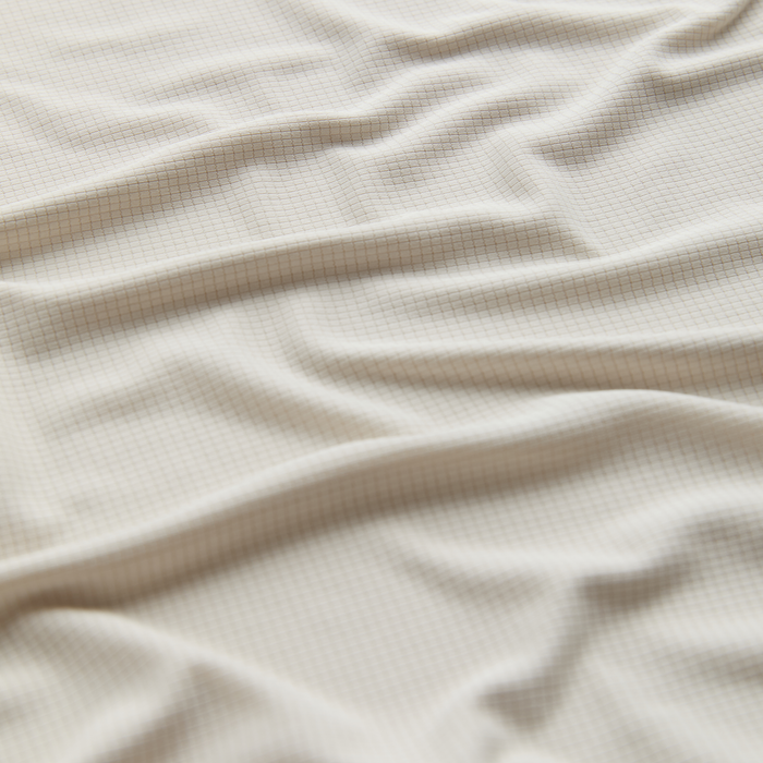 Cozy and earth-toned outdoor travel linens spread out in a serene natural setting, perfect for enhancing any adventure with Roark.