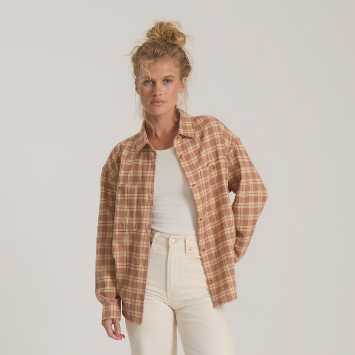 Amberley Light long sleeve flannel in cherrywood plaid worn open over white tee on model with cream pants