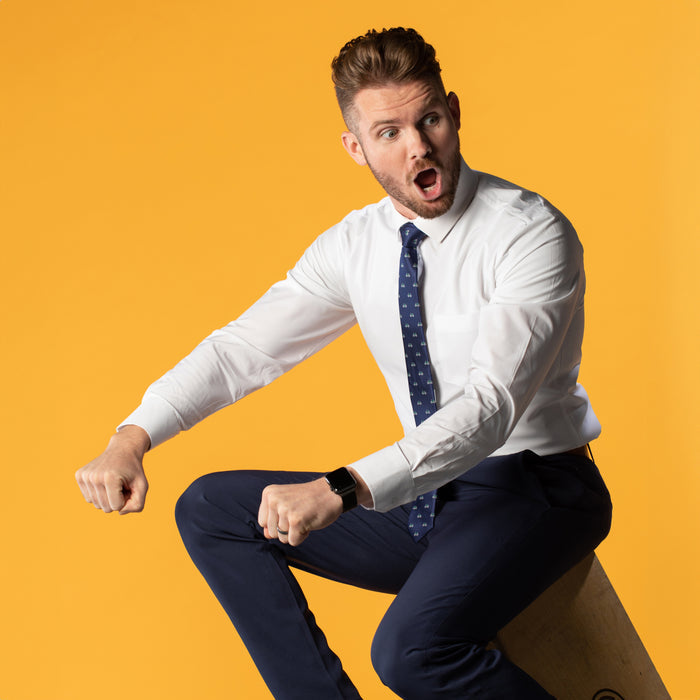 Navy blue tie with bicycles on white shirt