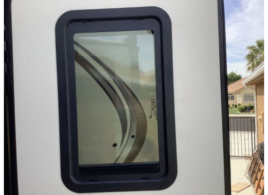 Black RV Entry Door Window Thin Shade - Installed Exterior View | United RV Parts