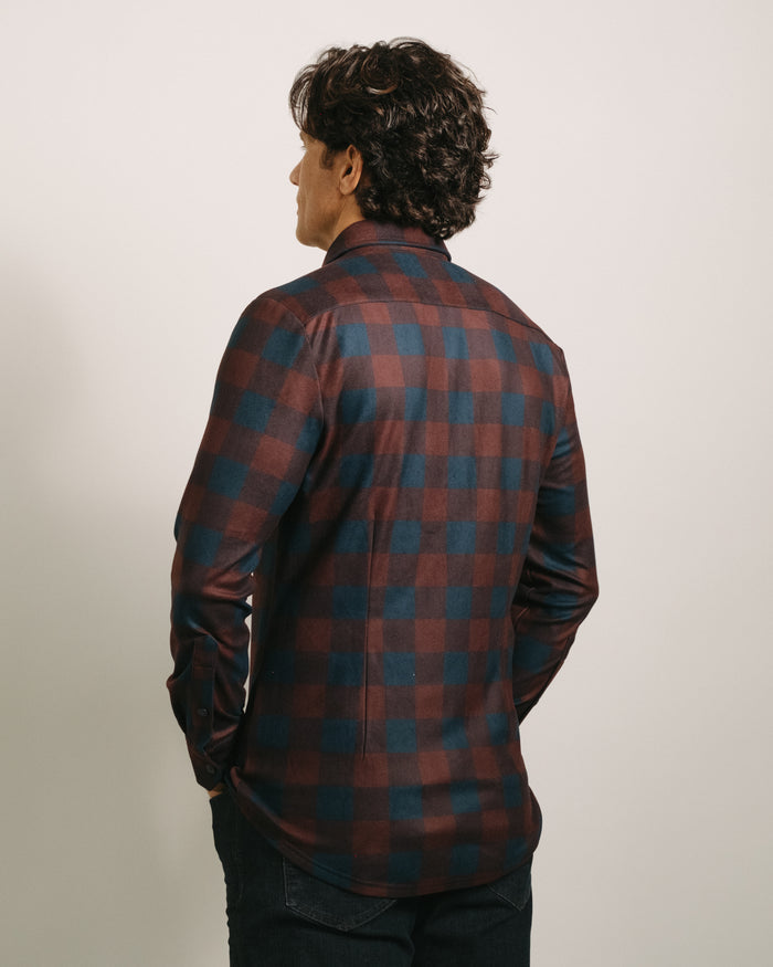 Back angle: Person wearing a Mulberry plaid (red and blue plaid) flannel shirt against a plain background