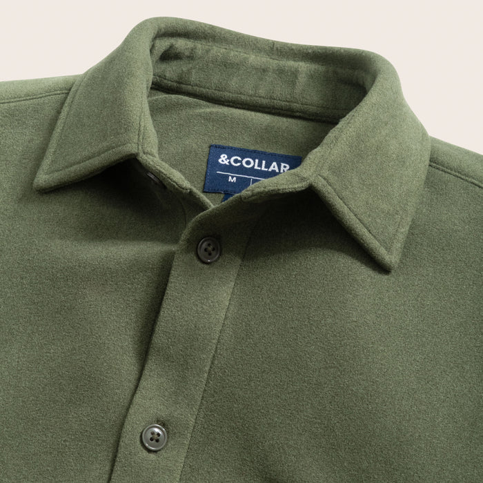Pine green flannel shirt with collar and buttons, featuring a brand label on a light gray background.