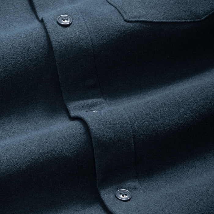 Close-up of a storm blue flannel button-up shirt with matching blue button details