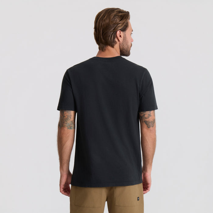 Man wearing black Augs Safe Camp Premium Tee from behind, paired with tan cargo shorts, against white background
