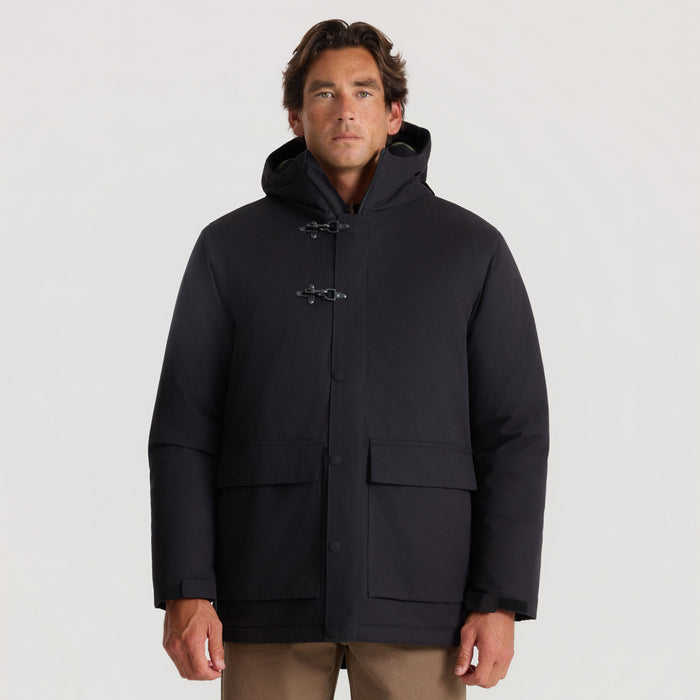 Black Axeman Parka Jacket with toggle closures and hood worn by man against neutral background
