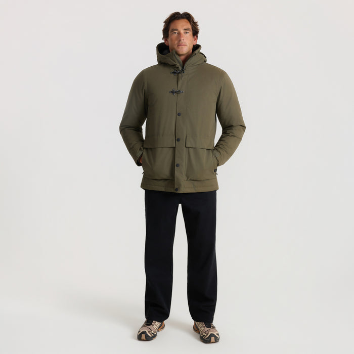 Axeman Parka Jacket in military green worn by man standing against neutral background in full-length view