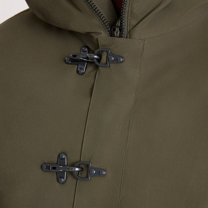 Olive green Axeman Parka jacket detail shot showing two black toggle fasteners and gray zip pull on chest