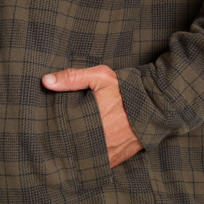Backwoods Jacket in military tan and navy plaid worn by model, close-up detail of sleeve and fabric texture
