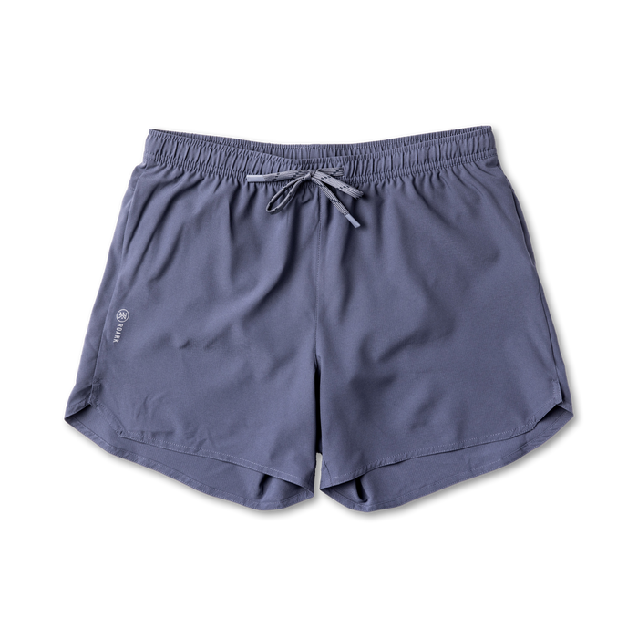 Assorted Roark adventure-ready shorts including active shorts, trunks, and Bermuda shorts displayed against an outdoor backdrop, ideal for travel and exploration.