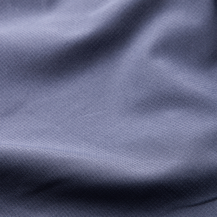 Close-up of textured woven grey fabric, ideal for durable outdoor apparel