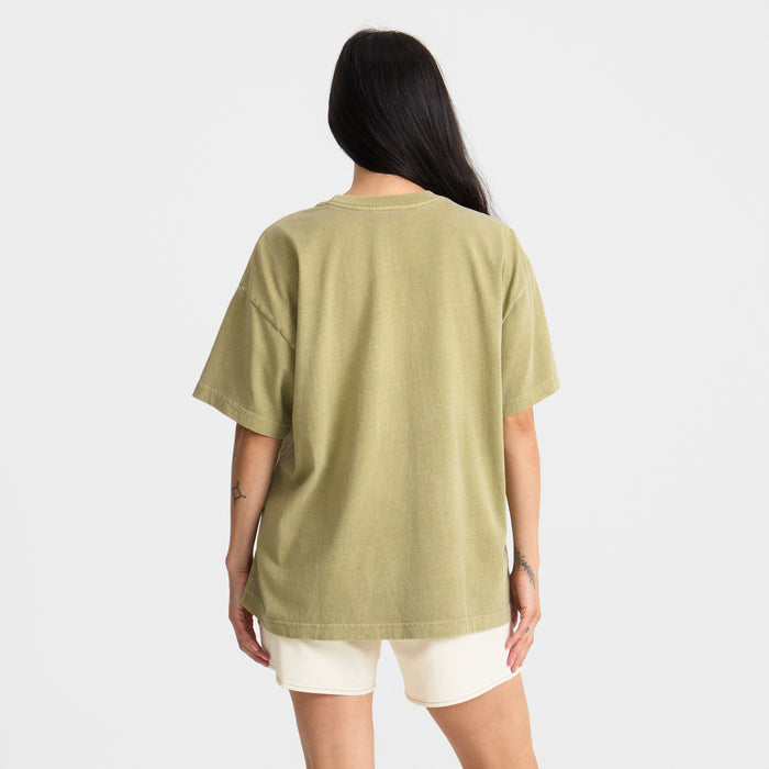 Active shirt with sleeves designed for adventure and travel in a natural outdoor setting.