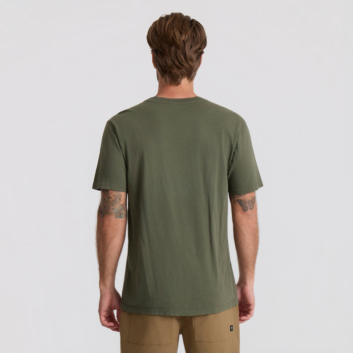 Roark active shirt in a military green, designed for adventure and outdoor activities, displayed in a natural setting.