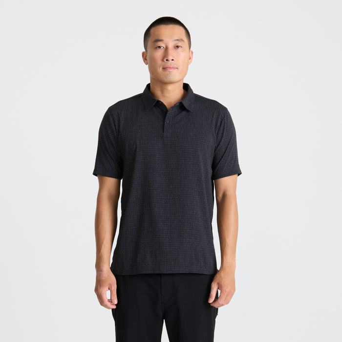 Close-up of a versatile black polo shirt with a distinctive collar, designed for active and outdoor adventures, featuring high-quality fabric perfect for travel and exploration.