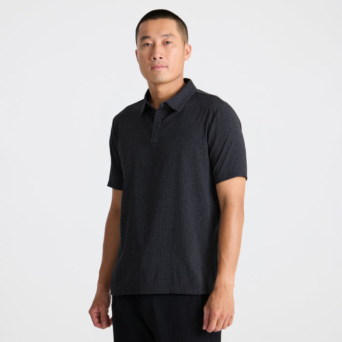 Close-up of a black polo shirt highlighting the sleeve and collar design, embodying Roark's adventure-ready apparel.