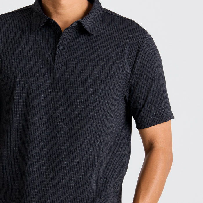 Close-up of a black active polo shirt featuring distinctive sleeves, collar, and buttons, ideal for adventure and outdoor activities.