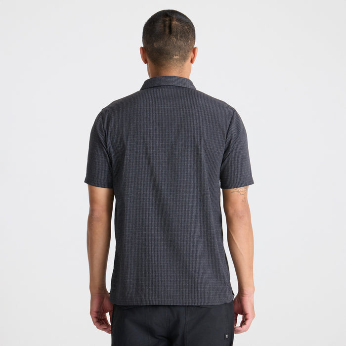 Roark active black shirt on a backdrop of rugged mountain terrain, depicting a sense of adventure and travel