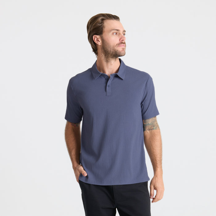 Close-up of a Roark active polo shirt detailing the collar and sleeve, designed for adventure and travel.