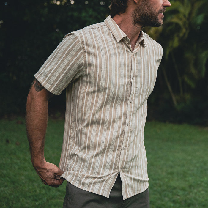 Close-up of the stylish details on a Roark Bless Up shirt, showcasing the sleeve, collar, and buttons, perfect for adventure and travel.