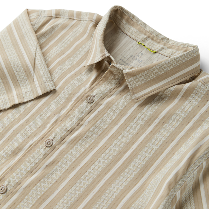 Close-up of a linen dress shirt featuring a detailed collar and button design, embodying Roark's commitment to adventure-ready apparel.