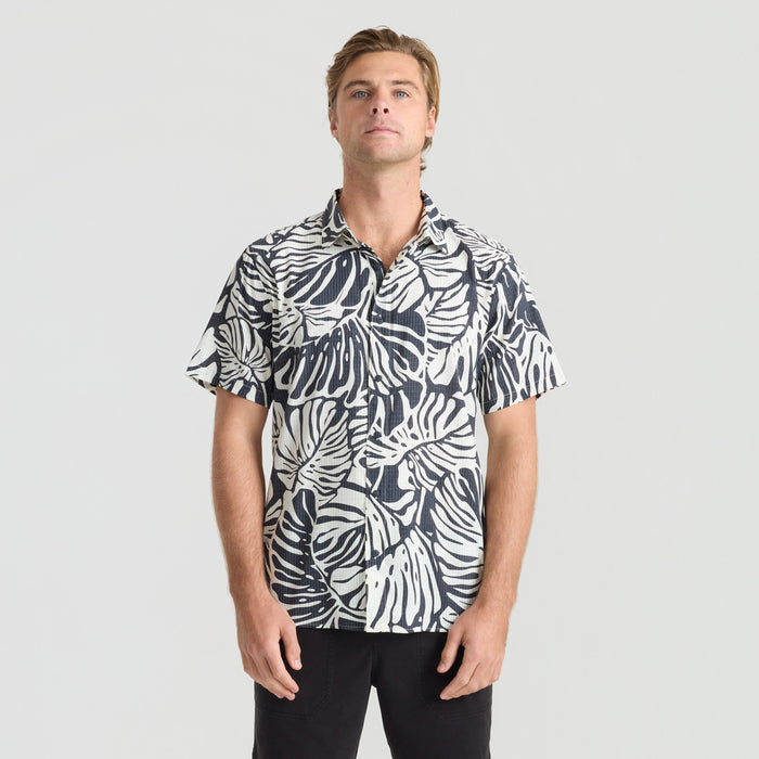 Close-up view of a rugged, adventure-ready shirt collar with durable button details, designed for both travel and outdoor activities by Roark.
