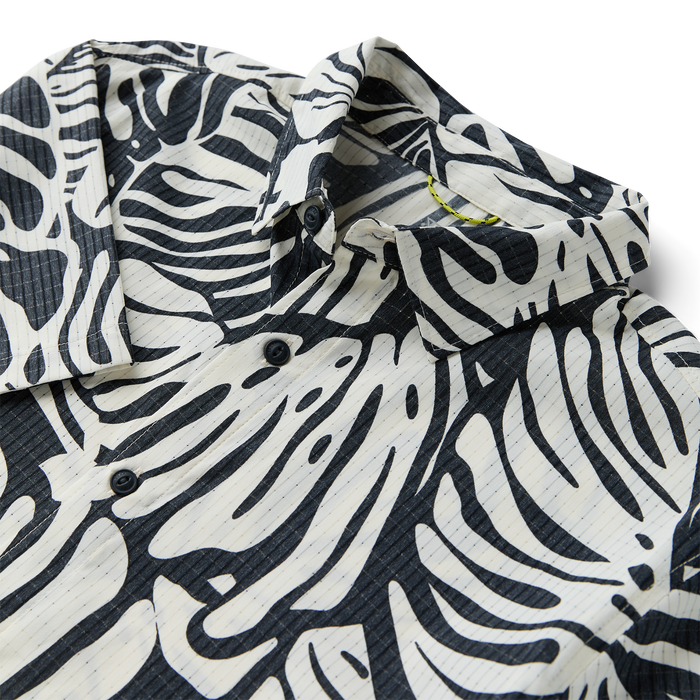 Close-up of a rugged Roark dress shirt featuring detailed sleeve, collar, and button design with a distinctive pattern, perfect for adventure and travel.