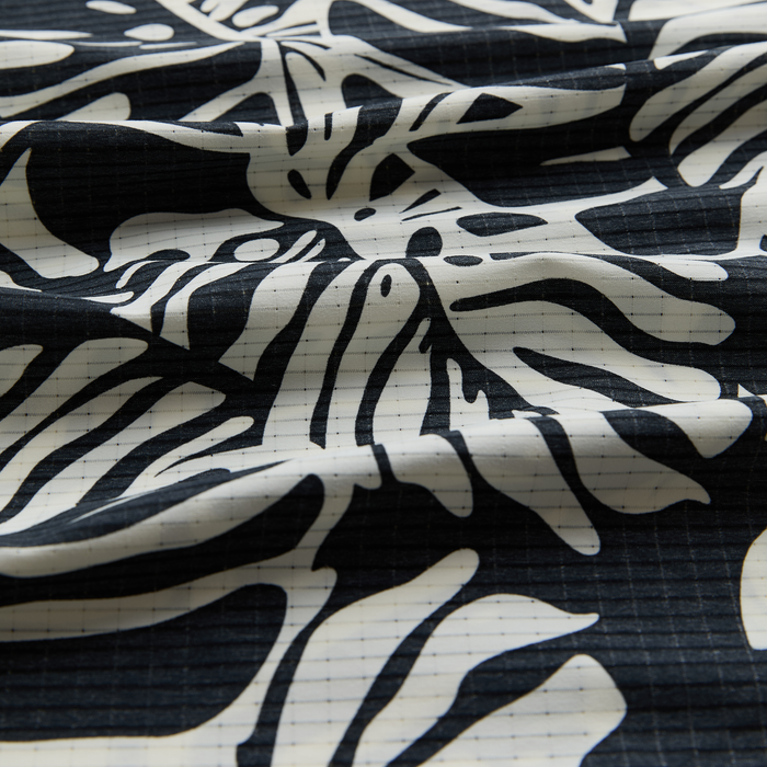 Assorted adventure gear in neutral colors of white, black, grey, and silver, showcasing textiles and outdoor equipment.