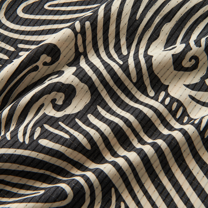 Front view of a man wearing Roark Bless Up Breathable Stretch Shirt in Black Wave, showcasing its unique pattern and comfortable fit for a variety of activities.