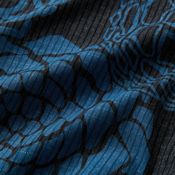 Close-up of a grey woven fabric with intricate patterns, exemplifying Roark's dedication to quality and adventure-ready apparel.