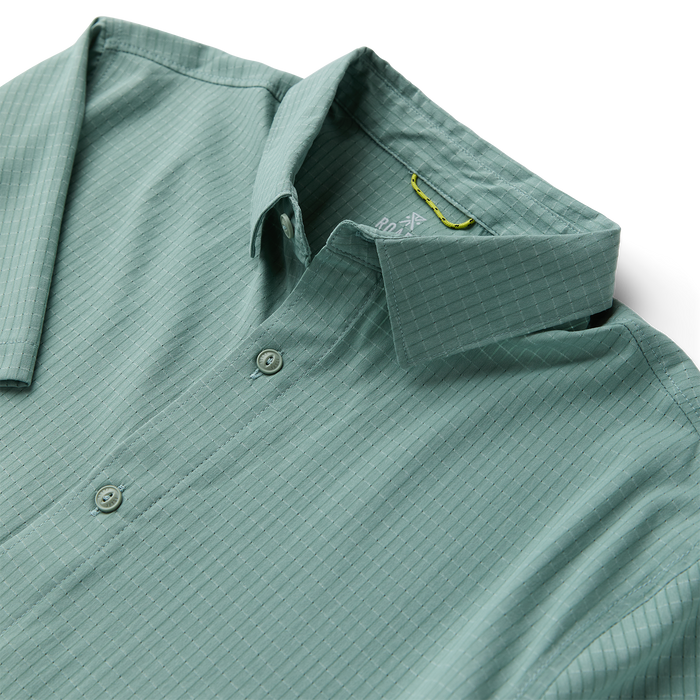 Close-up of a rugged Roark dress shirt featuring detailed collar and buttons, designed for adventure and travel