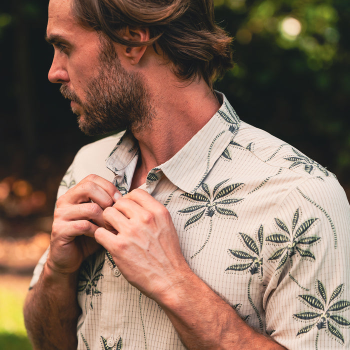 Close-up of a crisp dress shirt featuring detailed collar and buttons, perfect for outdoor or travel adventures with Roark.