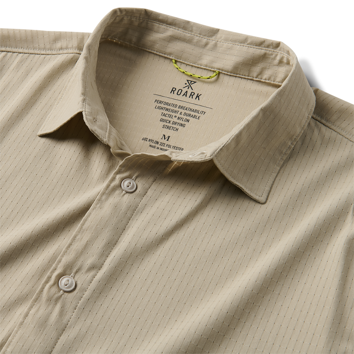 Detail shot of a Roark shirt collar and button, crafted for adventure and travel