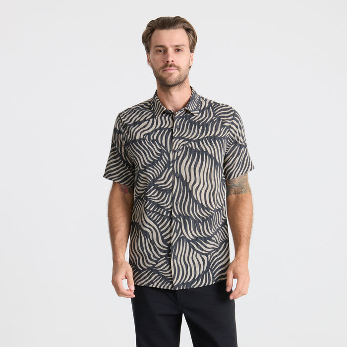 Close-up of a gray Roark adventure dress shirt highlighting the collar and button details, designed for travel and outdoor activities