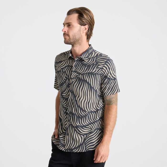 Close-up of a stylish grey dress shirt with detailed collar and buttons, embodying Roark’s commitment to durable and functional travel wear.