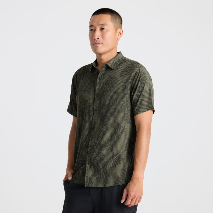 Close-up of a patterned active shirt detailing sleeve, collar, and button design, embodying Roark's adventure-inspired style