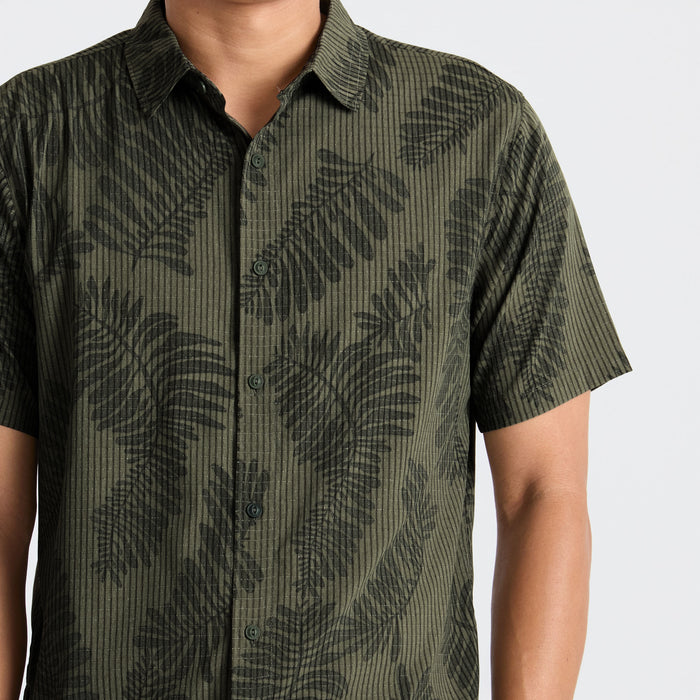 Camouflage active shirt featuring detailed button and collar design, ideal for outdoor adventures