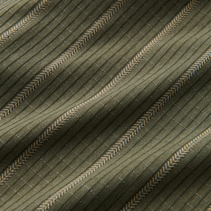 Close-up texture of woven fabric, embodying Roark's dedication to durable and adventure-ready textiles.