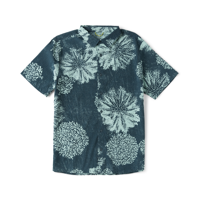 Close-up of a stylish Roark shirt featuring intricate patterns and motifs on the sleeve and collar, designed for adventure and travel.