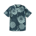 Close-up of a stylish Roark shirt featuring intricate patterns and motifs on the sleeve and collar, designed for adventure and travel.