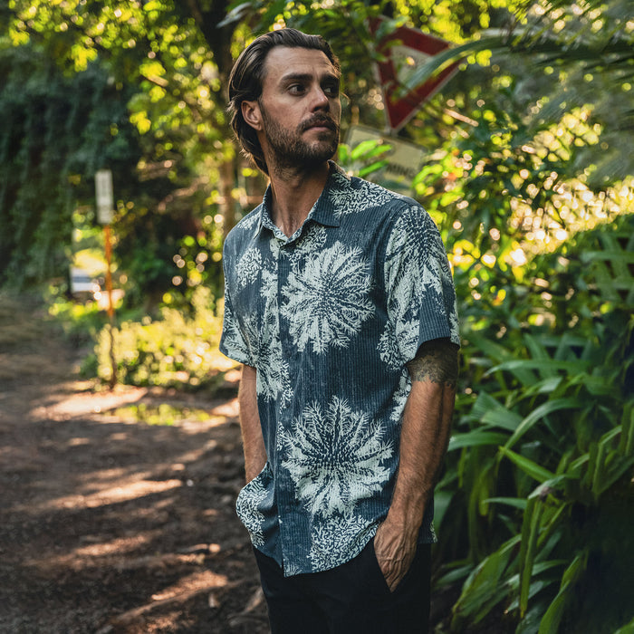 Active man wearing a Roark BlessUp shirt, featuring detailed sleeves, a stylish collar, and front buttons, perfect for adventure and travel.