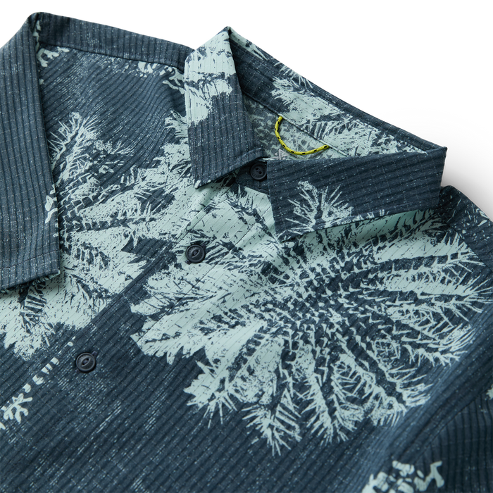 Man in Roark attire emphasizing an adventurous and travel-inspired lifestyle against an engaging outdoor backdrop.